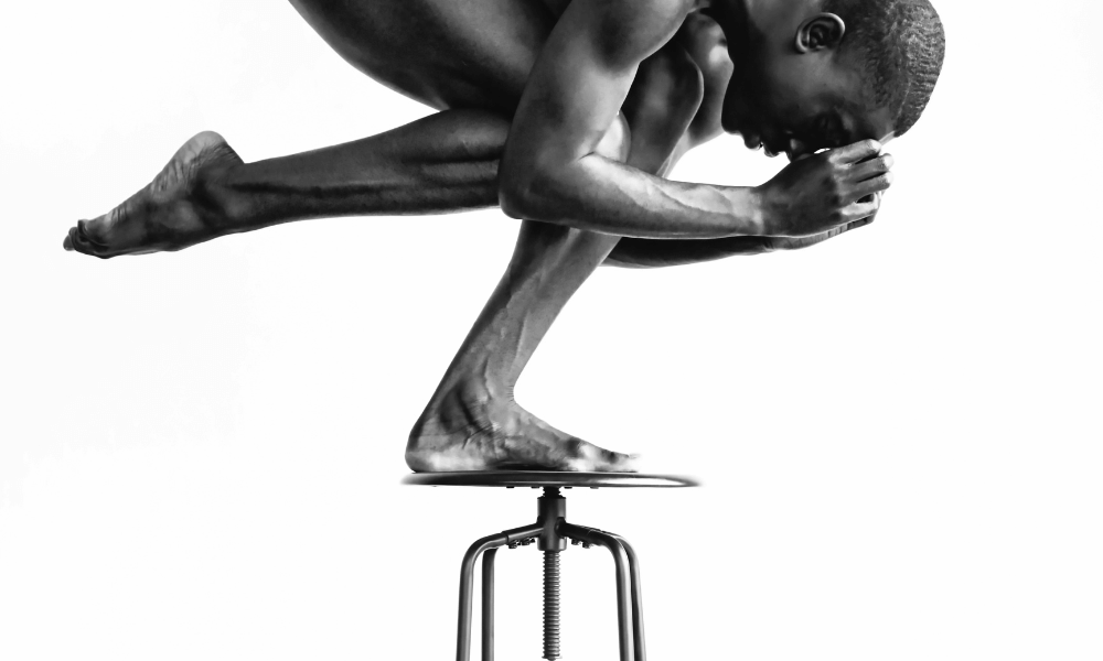 person balancing on a stool