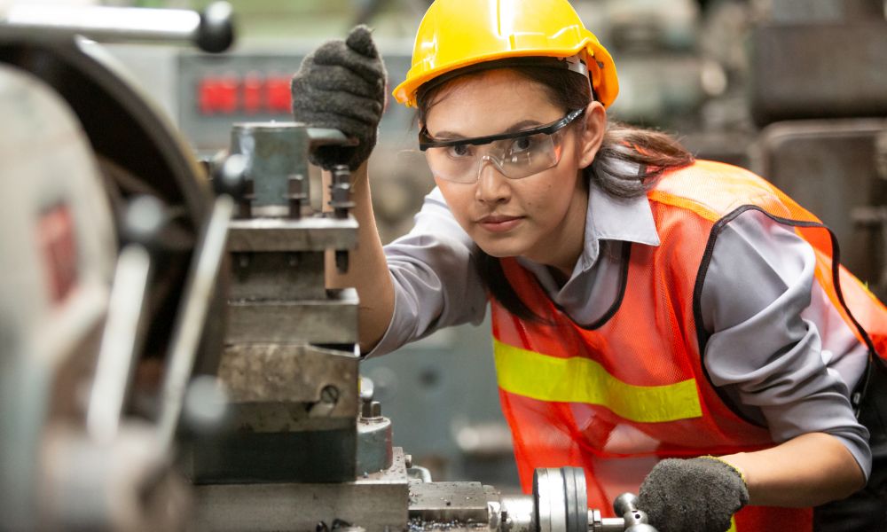 A worker operating a machine